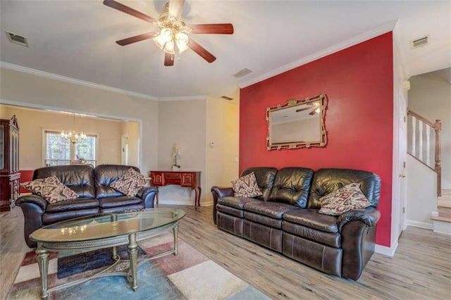 500 Nicole Ct SE, Conyers, GA 30094 - living room featuring crown molding, ceiling fan with notable chandelier, and light hardwood / wood-style flooring