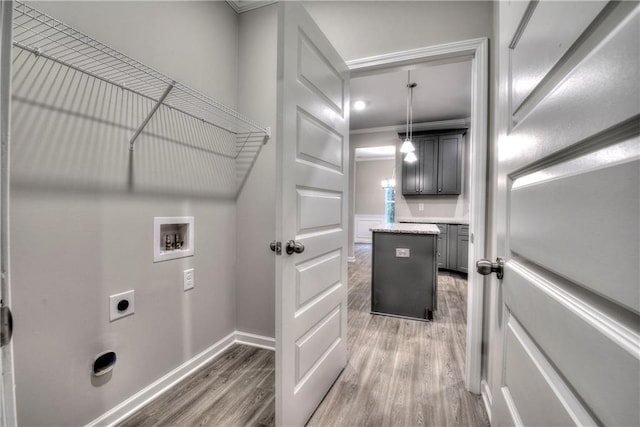 laundry room with hookup for an electric dryer, dark hardwood / wood-style floors, ornamental molding, and hookup for a washing machine