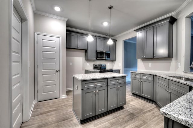 kitchen with pendant lighting, crown molding, gray cabinets, light stone countertops, and appliances with stainless steel finishes