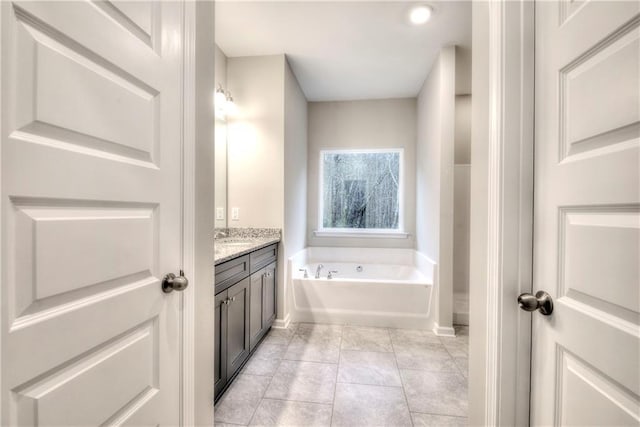 bathroom featuring a bath, vanity, and tile patterned floors