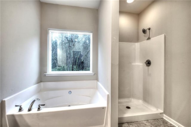 bathroom with shower with separate bathtub