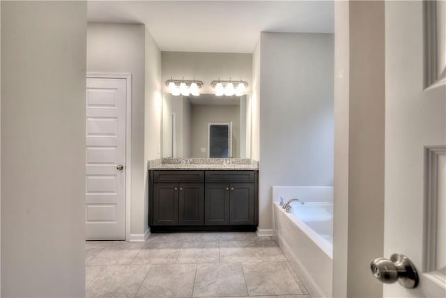 bathroom with tile patterned floors, vanity, and a bath