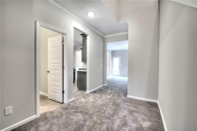 hallway with carpet flooring and ornamental molding