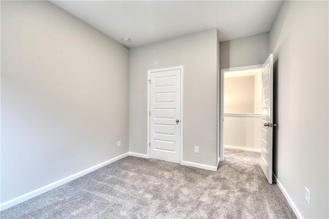 unfurnished bedroom with light carpet and a closet