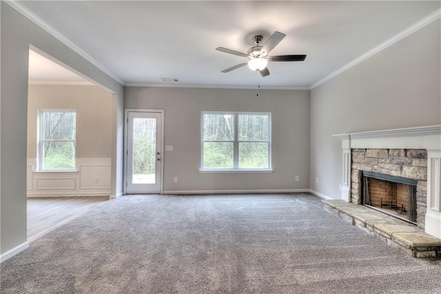 unfurnished living room featuring a fireplace, light carpet, and ornamental molding