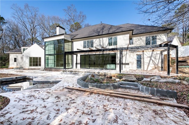 rear view of house featuring a patio and a pergola