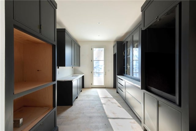 kitchen with gray cabinetry and light wood-type flooring