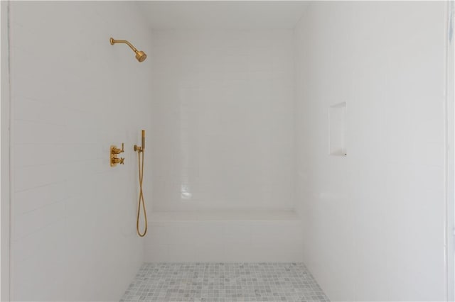 bathroom with a shower and tile patterned flooring