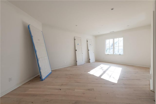 empty room with light hardwood / wood-style floors