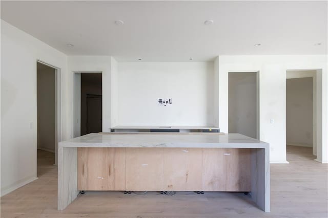 kitchen featuring light brown cabinetry and light wood-type flooring