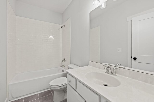 full bathroom with toilet, vanity, tile patterned floors, and tub / shower combination