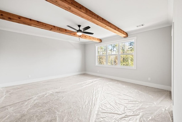 empty room featuring ornamental molding, beamed ceiling, ceiling fan, and carpet floors