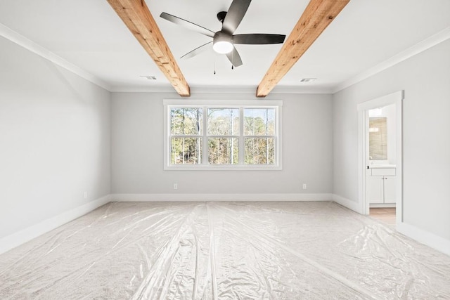 empty room with carpet floors, ceiling fan, beamed ceiling, and ornamental molding