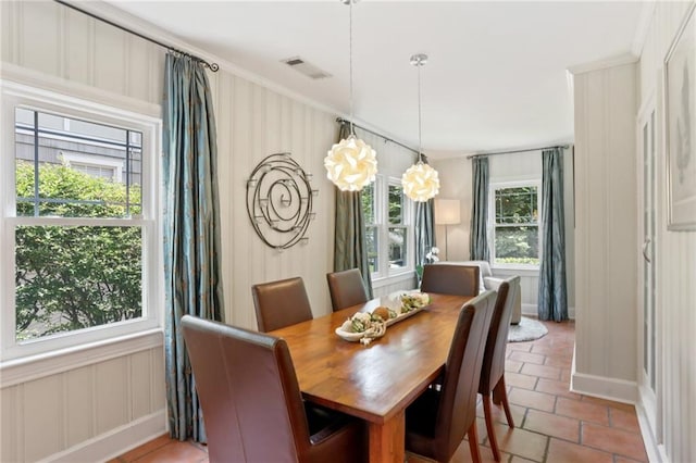 dining space with crown molding