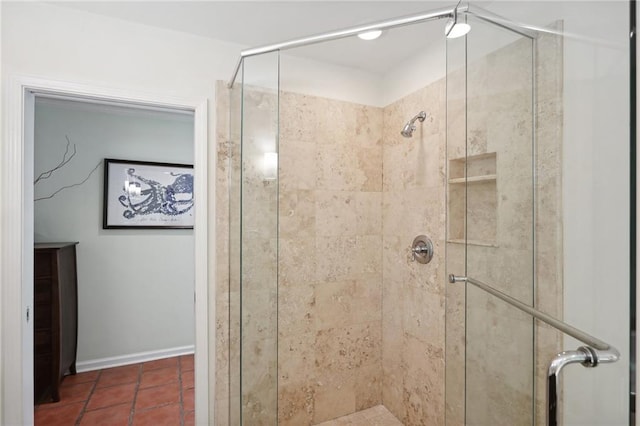 bathroom with an enclosed shower and tile patterned floors