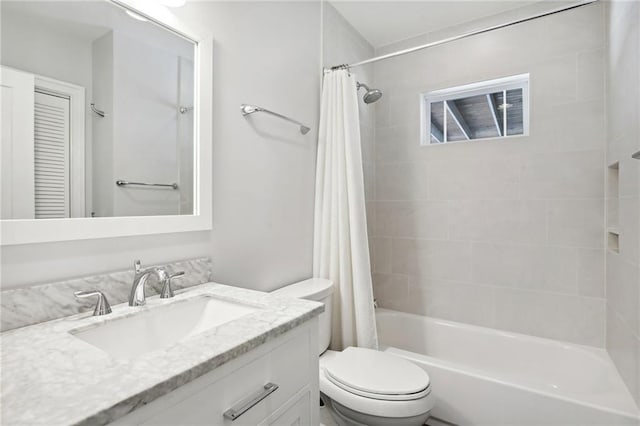 full bathroom featuring vanity, shower / bath combo, and toilet