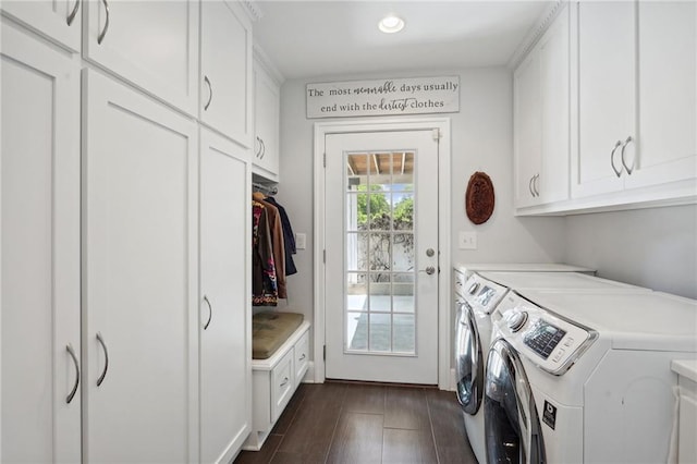 laundry area with cabinets, dark hardwood / wood-style flooring, and washing machine and dryer