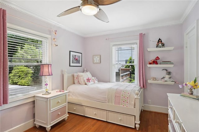 bedroom featuring hardwood / wood-style flooring, ornamental molding, and ceiling fan