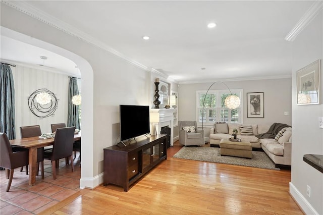 living room with ornamental molding and light wood-type flooring