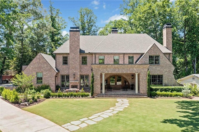 3146 Frontenac Ct NE, Atlanta, GA 30319 - view of front of property featuring a chimney, brick siding, a front yard, and french doors