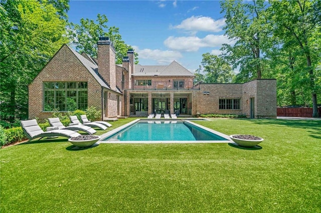 3146 Frontenac Ct NE, Atlanta, GA 30319 - back of property with a balcony, a chimney, an outdoor pool, brick siding, and a patio