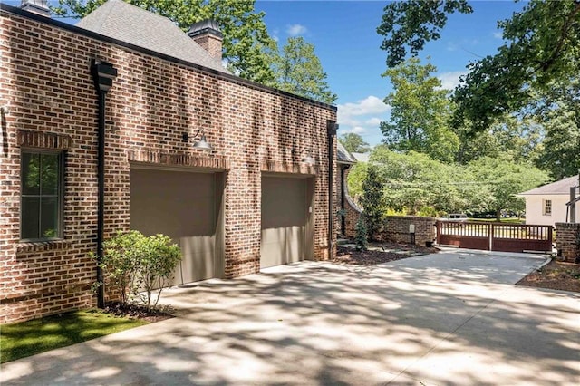 3146 Frontenac Ct NE, Atlanta, GA 30319 - view of home's exterior with brick siding, a chimney, and driveway