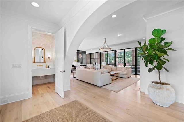 3146 Frontenac Ct NE, Atlanta, GA 30319 - living area with arched walkways, a chandelier, light wood-type flooring, recessed lighting, and baseboards