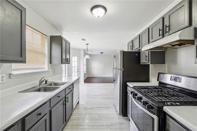 2205 Dresden Grn NW, Kennesaw, GA 30144 - kitchen with stainless steel gas range oven, light wood-type flooring, under cabinet range hood, a sink, and white dishwasher