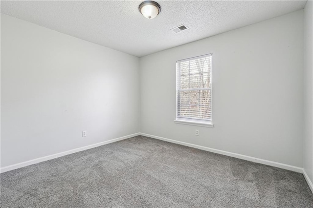 2205 Dresden Grn NW, Kennesaw, GA 30144 - unfurnished room featuring baseboards, visible vents, carpet floors, and a textured ceiling