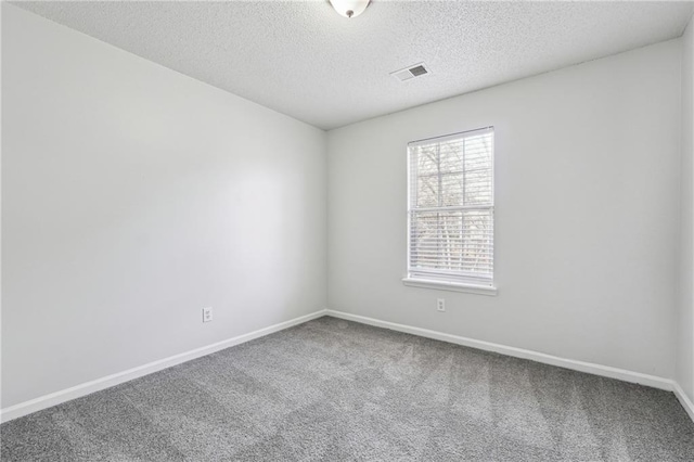 2205 Dresden Grn NW, Kennesaw, GA 30144 - empty room with visible vents, baseboards, a textured ceiling, and carpet flooring