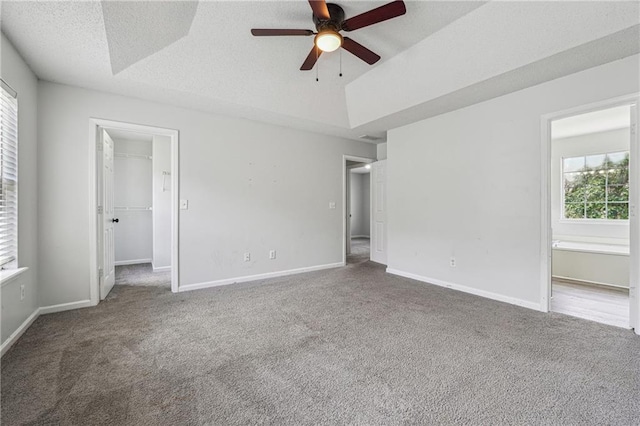 2205 Dresden Grn NW, Kennesaw, GA 30144 - unfurnished bedroom with baseboards, a spacious closet, and carpet flooring