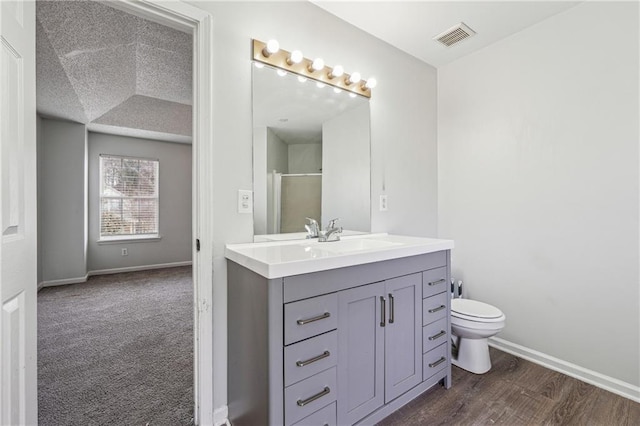 2205 Dresden Grn NW, Kennesaw, GA 30144 - bathroom with vanity, baseboards, visible vents, a stall shower, and toilet