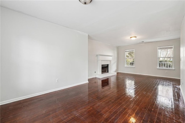 2205 Dresden Grn NW, Kennesaw, GA 30144 - unfurnished living room with a fireplace with raised hearth, baseboards, and hardwood / wood-style floors