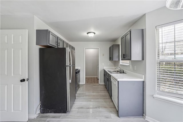 2205 Dresden Grn NW, Kennesaw, GA 30144 - kitchen featuring gray cabinetry, light wood-style flooring, a sink, freestanding refrigerator, and light countertops