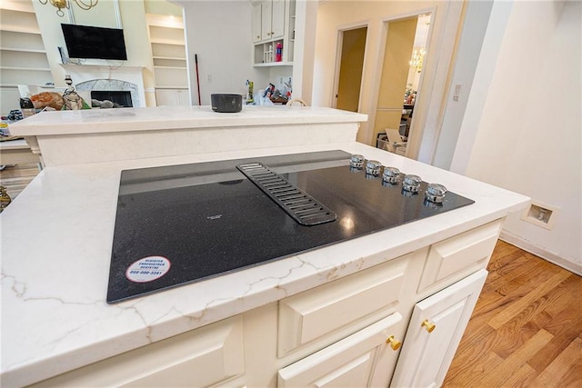 kitchen with light stone countertops and light hardwood / wood-style flooring