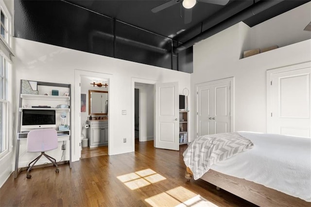 bedroom with a high ceiling, a closet, and wood finished floors