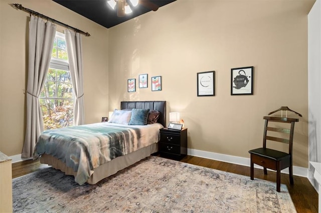 bedroom featuring wood finished floors and baseboards