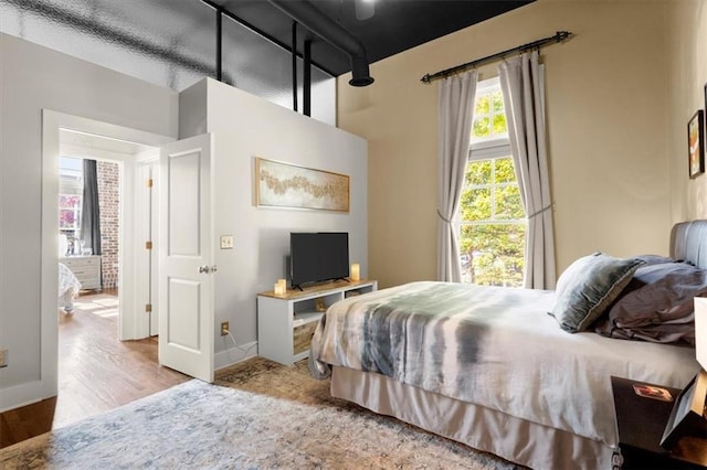 bedroom featuring baseboards and wood finished floors