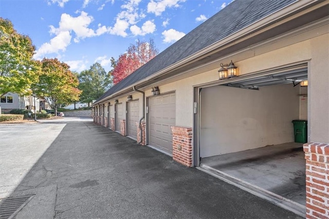 exterior space featuring a garage and stucco siding