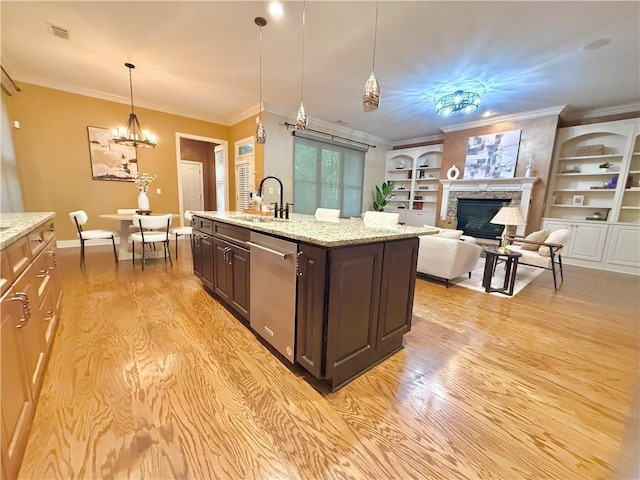 kitchen featuring dark brown cabinetry, a sink, light wood finished floors, dishwasher, and visible vents