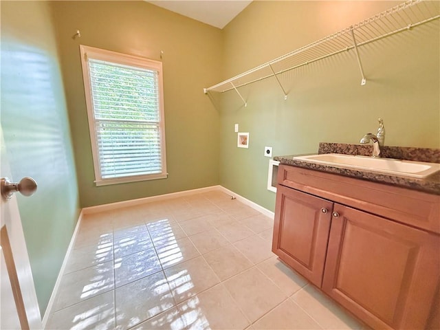 washroom featuring laundry area, a sink, washer hookup, light tile patterned floors, and hookup for an electric dryer
