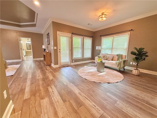 sitting room featuring baseboards, ornamental molding, light wood finished floors, and visible vents