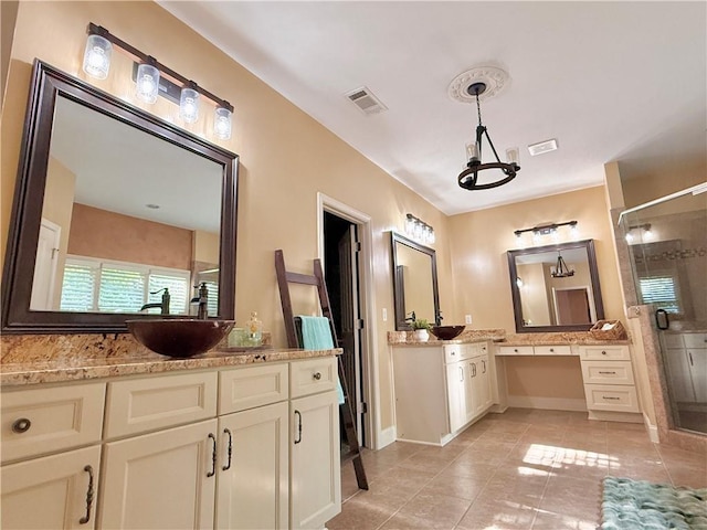 bathroom with visible vents, a shower stall, a sink, and tile patterned flooring