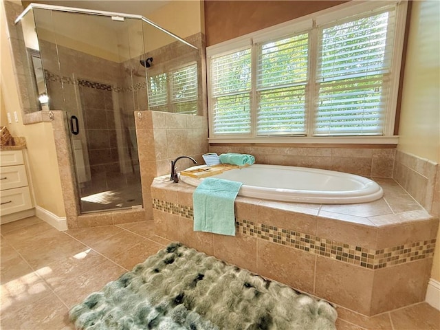 full bathroom with tile patterned floors, a shower stall, a wealth of natural light, and a bath
