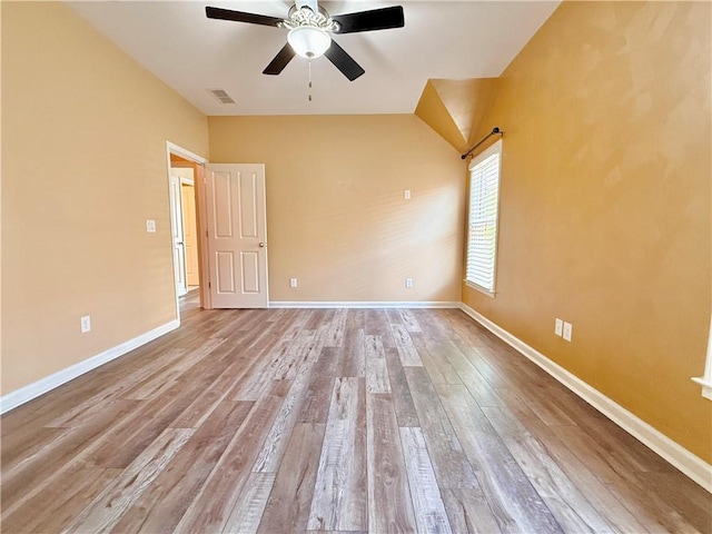 empty room with visible vents, baseboards, ceiling fan, and wood finished floors