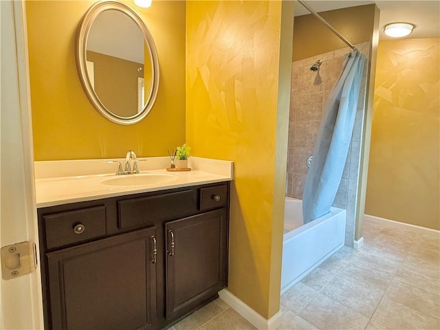 bathroom featuring vanity, baseboards, tile patterned flooring, and shower / tub combo with curtain
