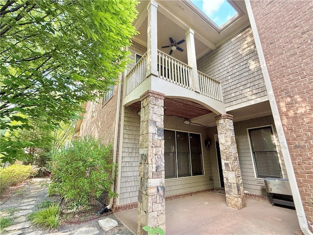 exterior space with ceiling fan, a balcony, and a patio area
