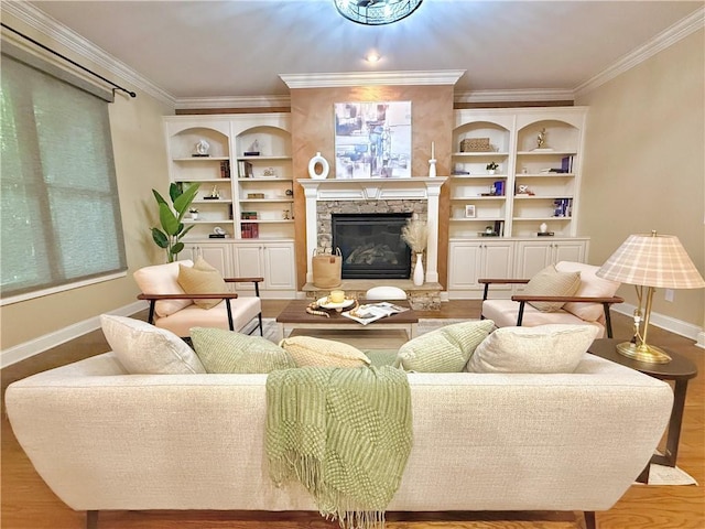 living room with baseboards, ornamental molding, wood finished floors, and a fireplace