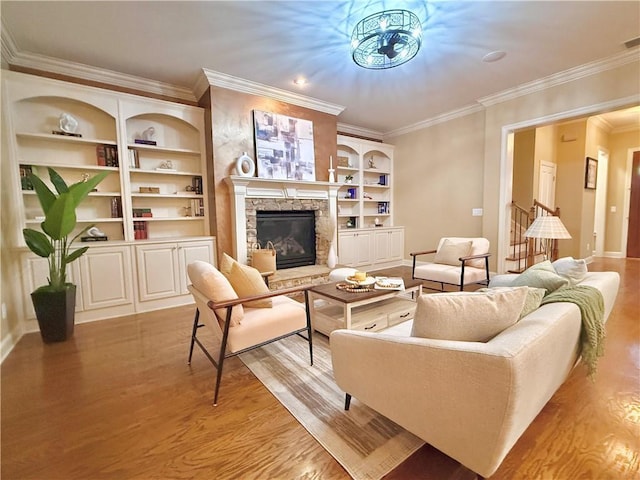 living room featuring crown molding, light wood finished floors, baseboards, and a fireplace