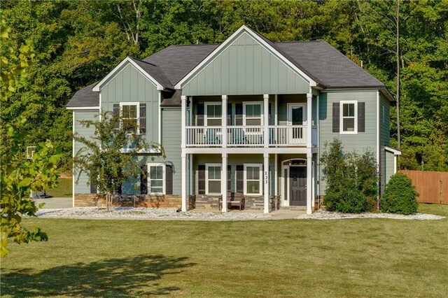 view of front of property with a front yard and a balcony